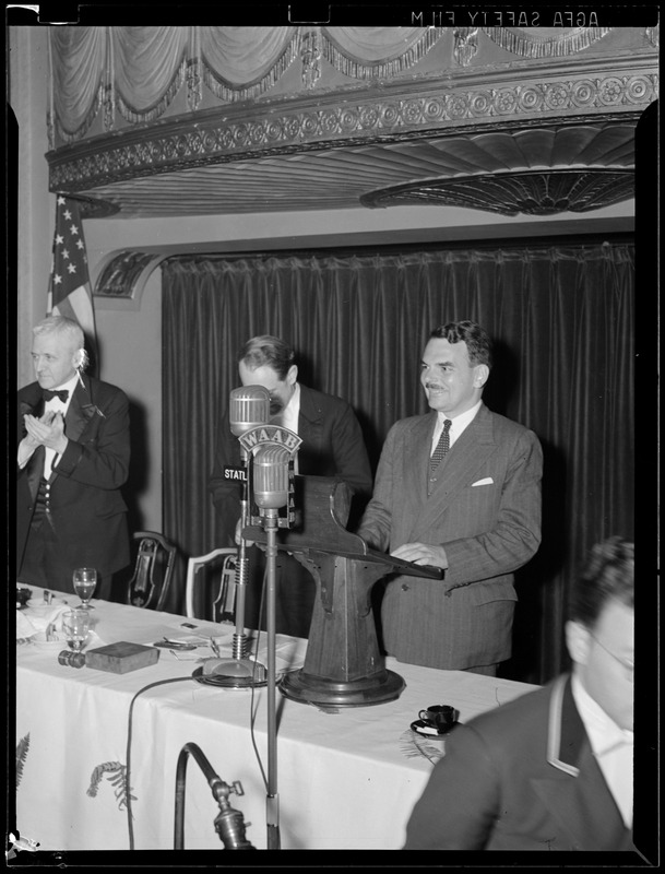 Man speaking from dais into WAAB microphone at the Statler Hotel