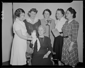 Women giving first aid demonstration, with WEEI microphone