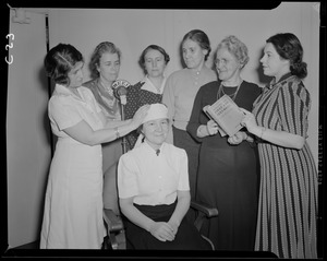 Women giving first aid demonstration, with WEEI microphone