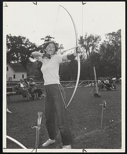 Betty Scott of Brookline gets set for a bullseye. Betty Scott of Brookline gets set for a bullseye. -- Below: An arrow can go through a target as this one did.