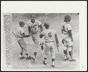 Delivers Big Blow for Dodgers -- Willie Davis, fleet Los Angeles Dodgers center fielder, is greeted at home plate after delivering three-run homer in 3rd inning of second game of twin bill against the Philadelphia Phillies today. Greeting him are Ron Fairly (6) and batboy. Phillies catcher is Bob Uecker.