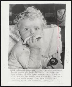 Little Girl Evacuated Twenty months old Kathy Mullen of the Sconticut Neck section of this town, munches on a sandwich after she and her family were evacuated from their home early today. They were housed in a Community house.