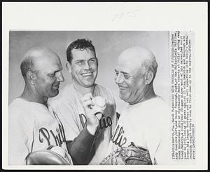 Familiar With Troubles of Pitchers - Coaches Andy Seminick, left, and Benny Bengough, right, of the Philadelphia Phillies, check knuckleball grip of righthander Robin Roberts at Phils' spring camp today. Roberts, a consistent 20-game winner most of his career, had worst year in 1957, losing 22 games against 10 wins. Seminick and Bengough are former big league backstops and can well sympathize with Robin's woes. Seminick caught Roberts when he first came up to the majors.