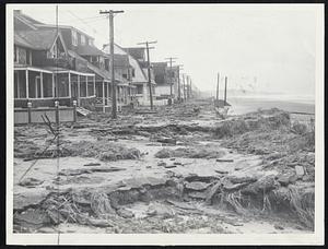 Proving Ground for Tanks is all the storm left at Beach avenue, in the Kenberma section of Hull. Note piazza of house at left, smashed by tons of water.