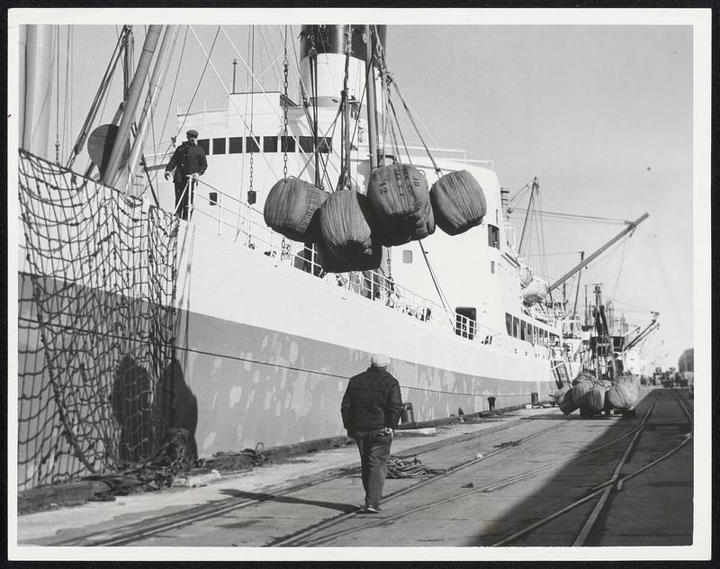 Wool Bales Unloaded--Bales of New Zealand wool are unloaded from "City of Brisbane," Australian freighter at Castle Island. Vessel was first of 15 to be worked yesterday after longshoremen ended 32-day strike. Total of 56 ships awaited handling by longshoremen.