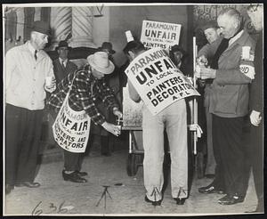 Pickets Get Coffee- Picket outside main entrance of Paramount studio at Hollywood help themselves to hot coffee brought from studio commissary during a rain drizzle. The jurisdictional strike made an estimated 20,000 idle.