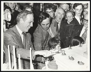 Smiling Mayor White does cake-cutting honors at Boston's 150th birthday party.