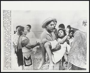 Remove Victims of Mexican Earthquake -- Rescue worker carries a girl injured in the earthquake yesterday that rocked Mexico's Pacific coast state of Guerrero, taking 31 lives. The victim is being taken into an emergency first aid post in the village of Coyuca de Catalan where 18 were killed in the quake.