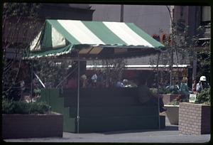 Seating covered by green and white canopy