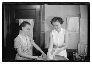 Women doing laundry with a washing machine