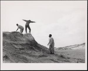 Three boys playing at the beach