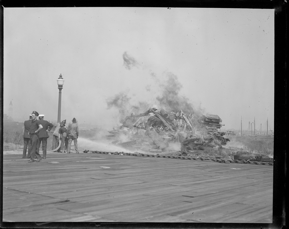 Burning decayed wood taken from USS Constitution during reconstruction