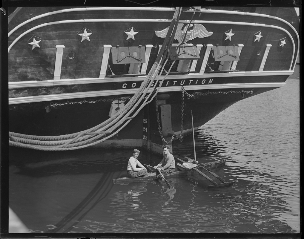 Outrigger rowboat under stern of USS Constitution