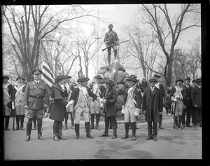 Men in colonial dress in front of minuteman stature, Lexington