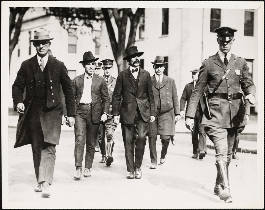 Sacco (2nd from left) and Vanzetti (with mustache) en route to court house, Oct 2, 1923