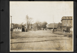 View looking west on Pearl Street toward Hancock Street showing railroad crossing, gate-tenders house on left, cobbler shop, and window of Hampton house on right.
