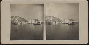 Small boats by a snow covered landscape