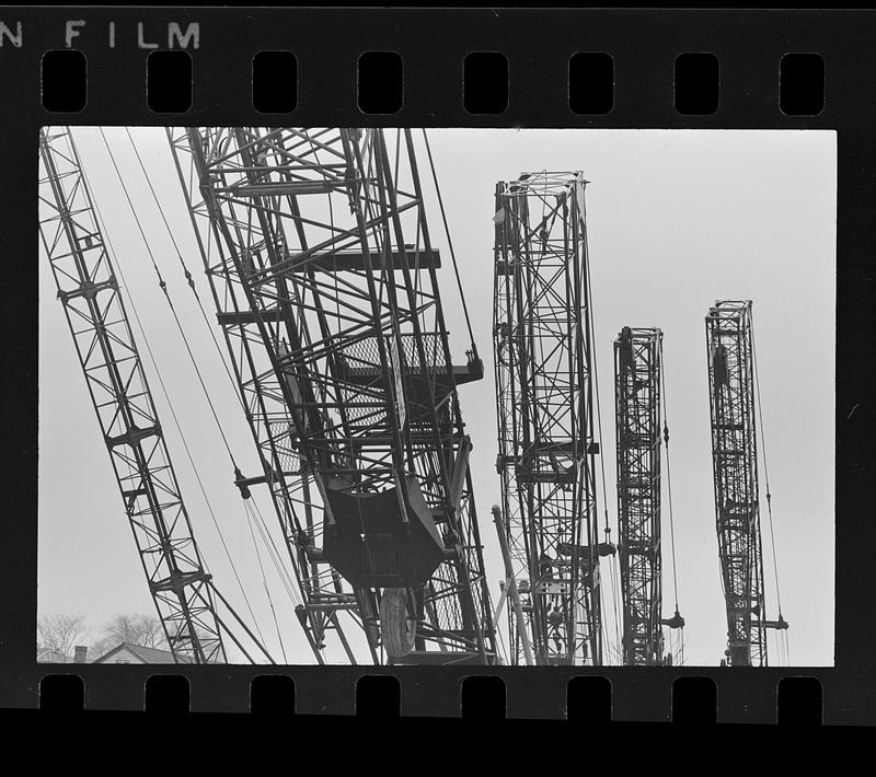 Folded construction cranes in storage yard, Everett