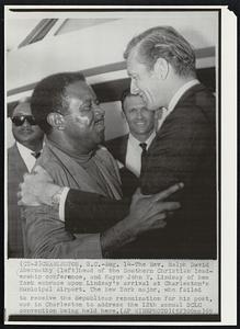 The Rev. Ralph David Abernathy (left) head of the Southern Christian leadership conference, and Mayor John V. Lindsay of New York embrace upon Lindsay's arrival at Charleston's Municipal Airport. The New York major, who failed to receive the Republican renomination for his post, was in Charleston to address the 12 th annual SCLC convention being held here.