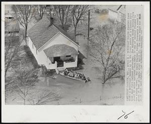 Motorboat Visits Flooded Farm Home - A motorboat nudges up to the front porch of a flooded farm home near Fort Calhoun yesterday. The Missouri River bottom farm about 10 miles upstream from Omaha is one of several flooded by the rising river. The Omaha Weather Bureau forecasts a crest of about 26 feet at Omaha about April 17. The Omaha stage was 20.06 feet last night.