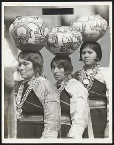 Balancing Jars on the Head no Trick For Them. Balancing expertly fashioned pottery jars on their heads, these Indians solemnly walk through the grounds of the inter-tribal ceremonial at Gallup, N.M., where thousands of southwestern Indians assembled. Note the elaborate necklaces, also fashioned by deft Indians hands.
