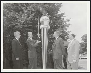 United Fund Torch, ignited at the Raytheon Manufacturing Co. in Waltham yesterday by Raytheon President Charles F. Adams, second, left, symbolized entrace of 16 industrial chapters into the fund. With Adams are Edward J. McDonald, left, president, Local 1505, electrical workers; O. Kelly Anderson, fund chairman, second right, and Joseph Connolly, president, Lodge 1836, machinists union.