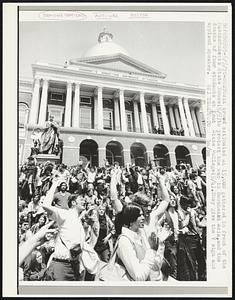 A crowd estimated at 15,000 gathered in front of the Massachusetts State House (5/5) to protest the war in Southeast Asia, and the deaths of four students at Kent State College (5/4). They gave the V sign and applaud speaker.