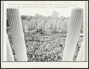 Framed through columns of the Mass. State House, a crowd of more than 10,000 persons gathered on the front steps protesting American entry in the war into Cambodia.