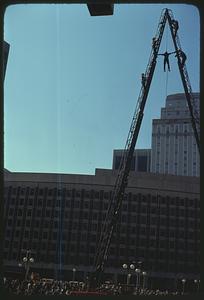 People, probably firemen, on an aerial ladder and descending down from it by rope, Boston City Hall Plaza