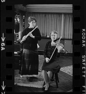 Lea Pearson playing flute and Florence Pearson playing violin