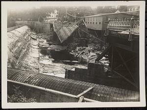 Remains of Main St. bridge, with dam and penstock, after flood waters receded