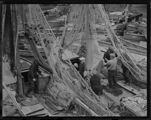 Italian fishermen repairing their nets at T-wharf