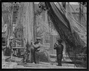 Italian fishermen mending nets
