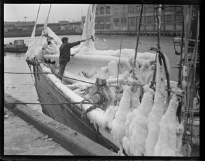 Hammering ice off the schooner Henrietta, at fish pier