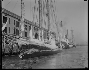 Ice clad fishing schooner docks at fish pier