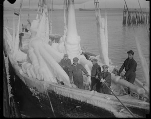 Crew hauls ice covered schooner Gov. Fuller into fish pier