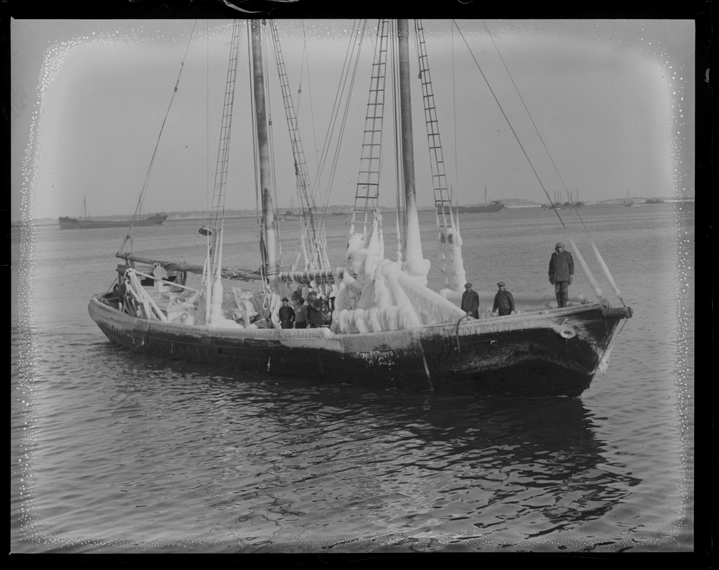 Fishing schooner Gov. Fuller clad with ice as she docks at fish pier