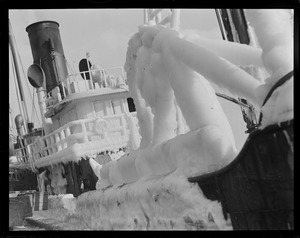 Ice covered steam trawler at fish pier