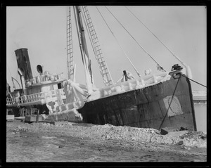 Ice covered steam trawler at fish pier