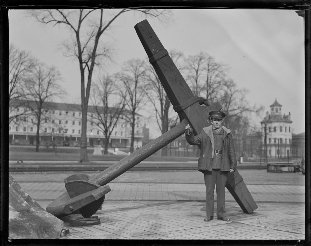 G.R. Dixon holding souvenir: miniature anchor of USS Constitution. They are being sold to raise money for reconstruction.