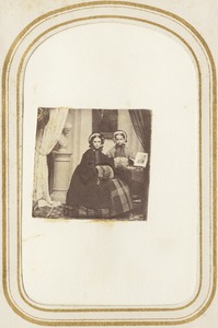 Portrait of two girls in coats and muffs [Miss Barker]