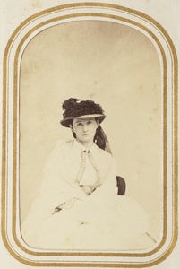 Portrait of a seated woman in a hat