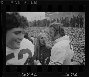 Boston College football players speaking with a woman at game against Holy Cross at Schaefer Stadium