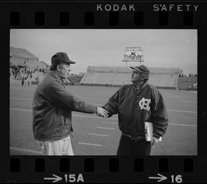 Boston College football coach Joe Yukica shakes hands with Holy Cross football coach Ed Doherty after a game at Schaefer Stadium