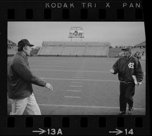Boston College football coach Joe Yukica and Holy Cross football coach Ed Doherty reach out for a handshake after a game at Schaefer Stadium
