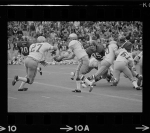 Boston College football players making a hand off in a game against Holy Cross at Schaefer Stadium