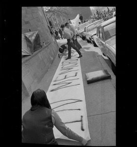 Students working on "In Memorium" banner stretched along a during protest against US march into Cambodia and the killing of four Ohio students at Kent State