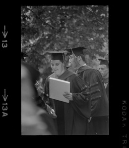 A member of the graduate class of Tufts University holding her diploma