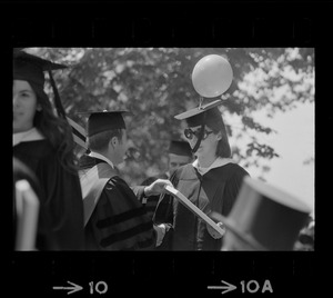 Tufts graduate Kris Young ties a balloon 'to be different' at commencement