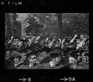 Members of the graduate class of Tufts University seen in the audience and moving their tassels
